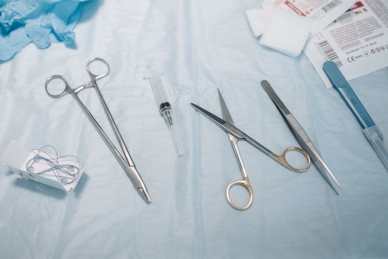 Flat lay of surgical instruments and medical supplies on a sterile table.