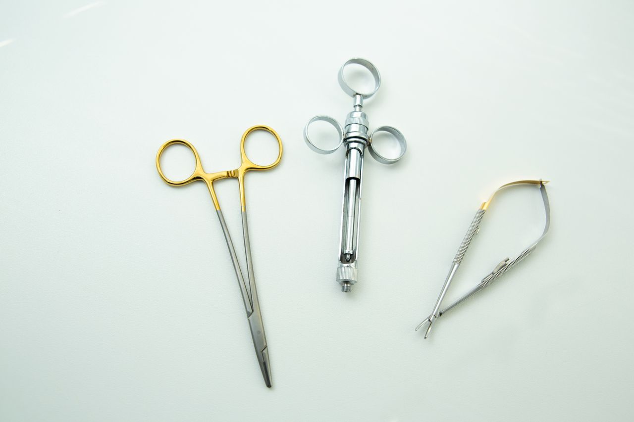 about-us-01 Close-up of surgical instruments on a clean white surface, highlighting precision tools.
